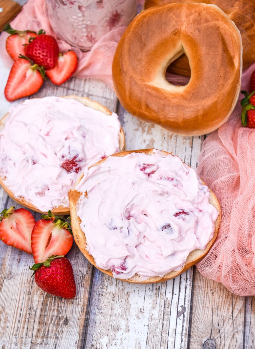 two bagels spread with homemade strawberry cream cheese spread