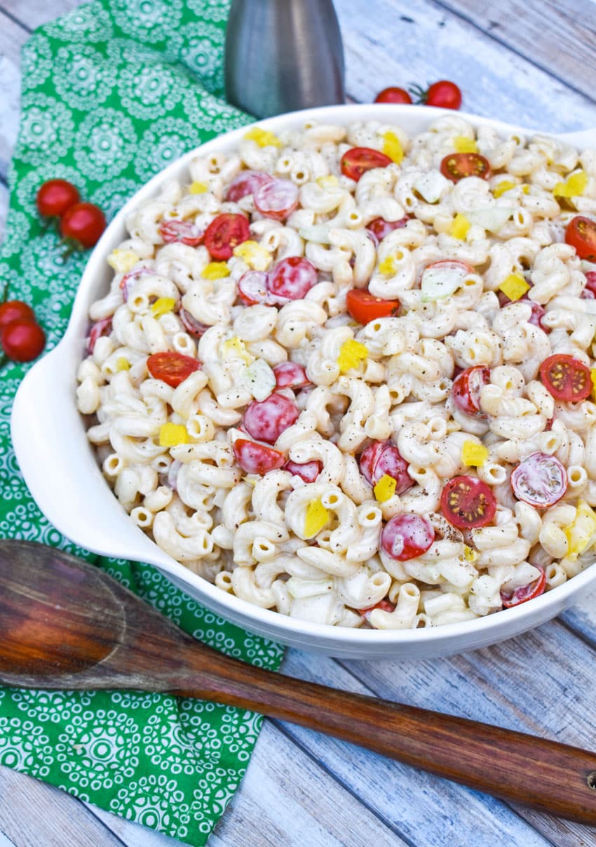 Grandma's classic macaroni salad in a white serving bowl