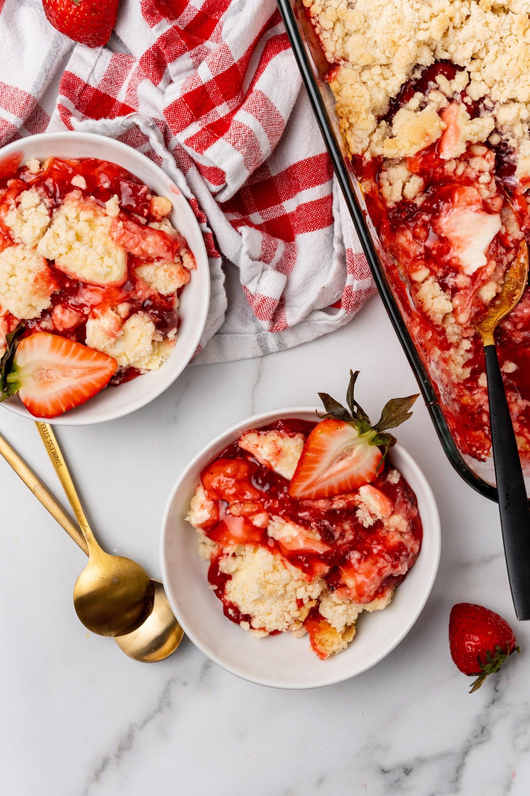 strawberry cheesecake dump cake served in a white bowl