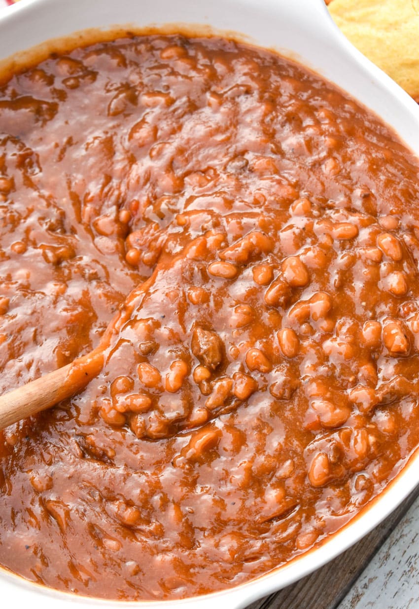smoked baked beans with brisket in a white serving bowl