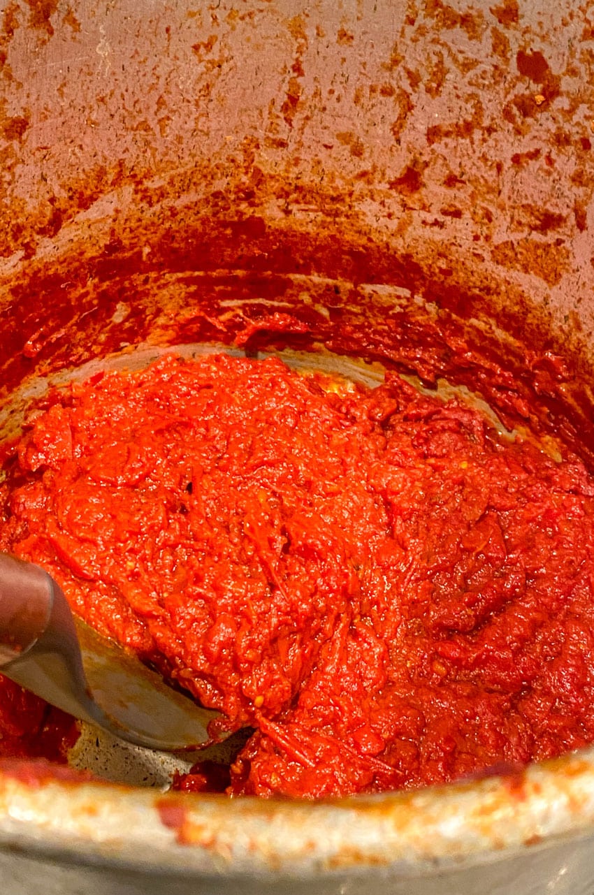 thickened homemade tomato paste in a large metal stock pot