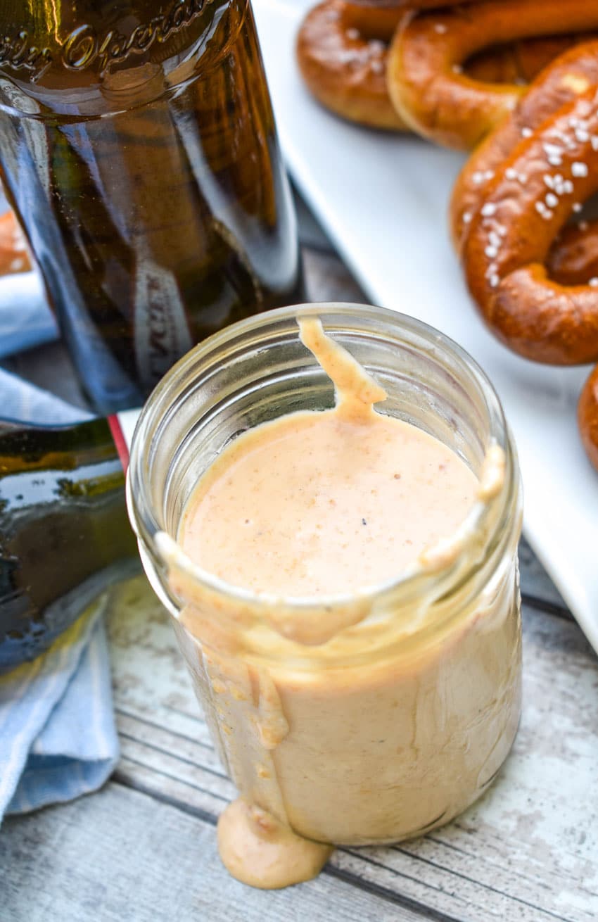 a glass jar filled with smoked beer cheese dip