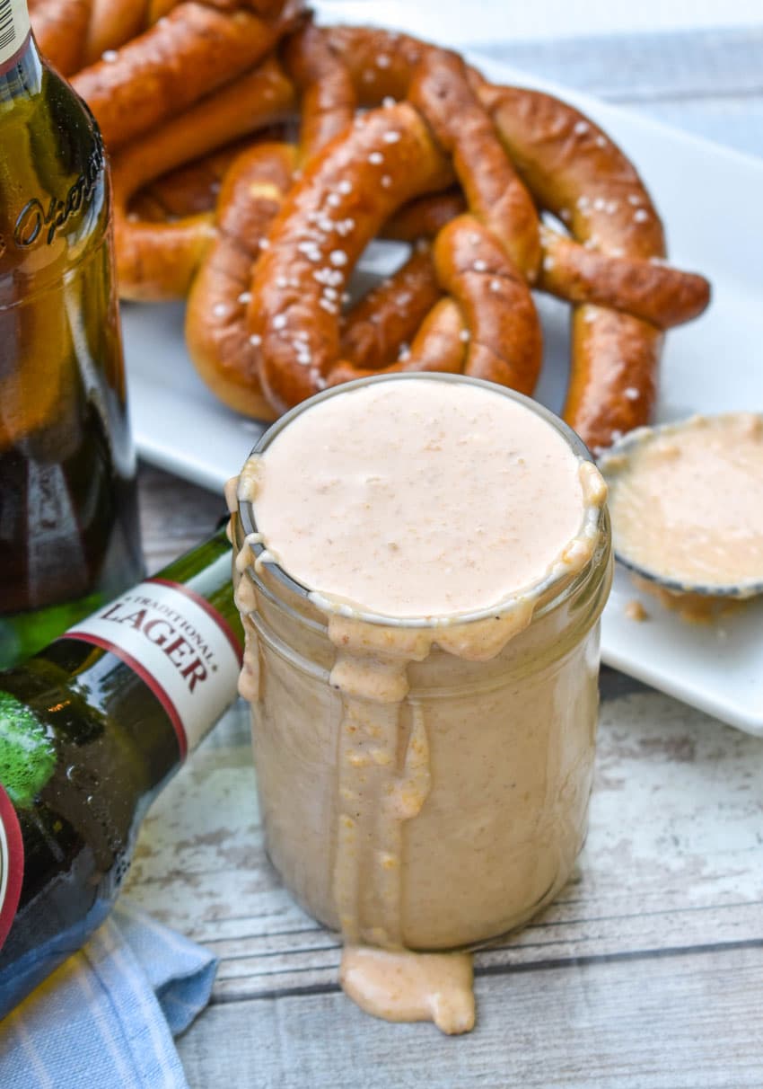 a glass jar filled with smoked beer cheese dip