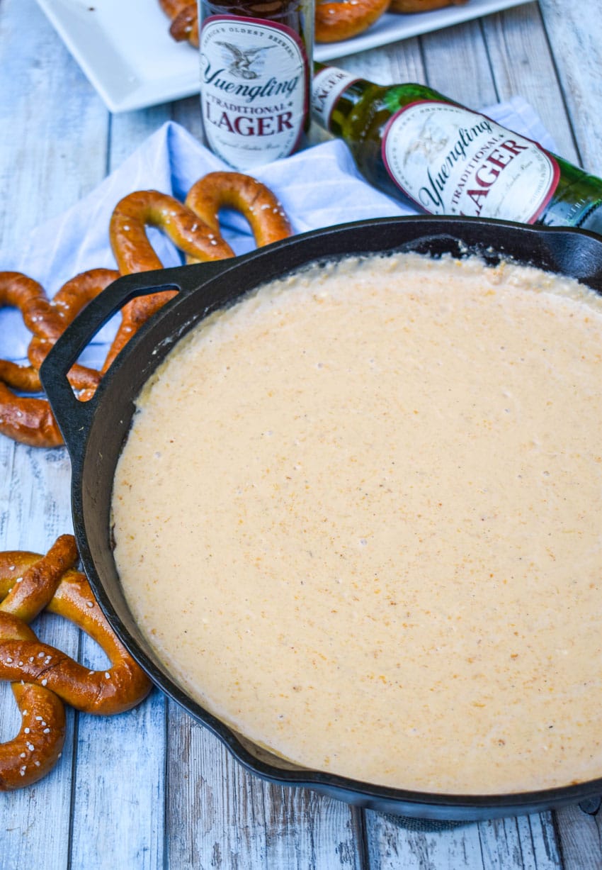 smoked beer cheese dip in a large cast iron skillet