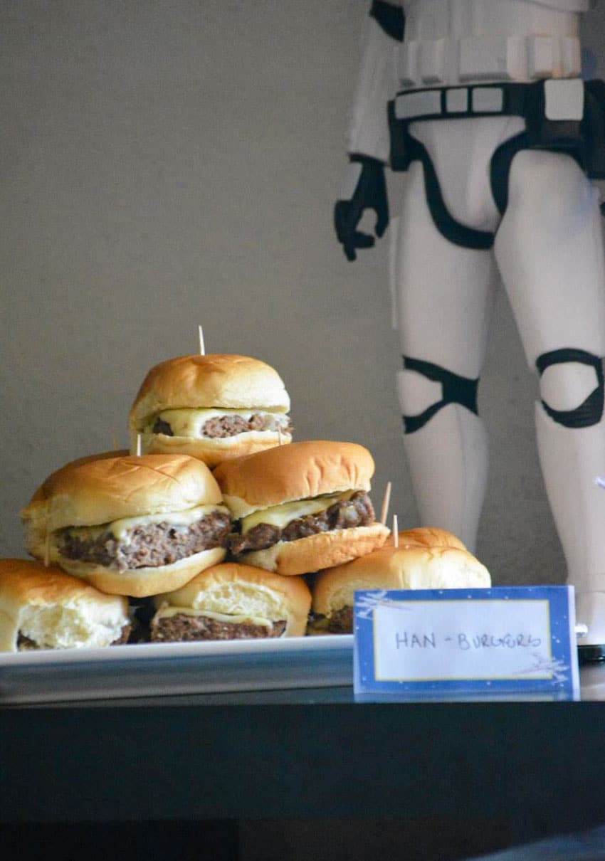 mini cheeseburger sliders on a white platter on a party food table