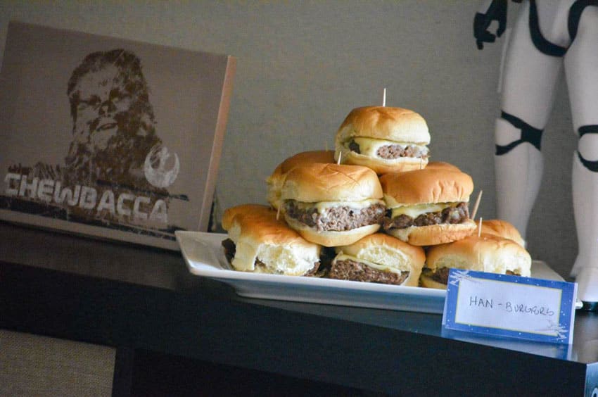 mini cheeseburger sliders on a white platter on a party food table