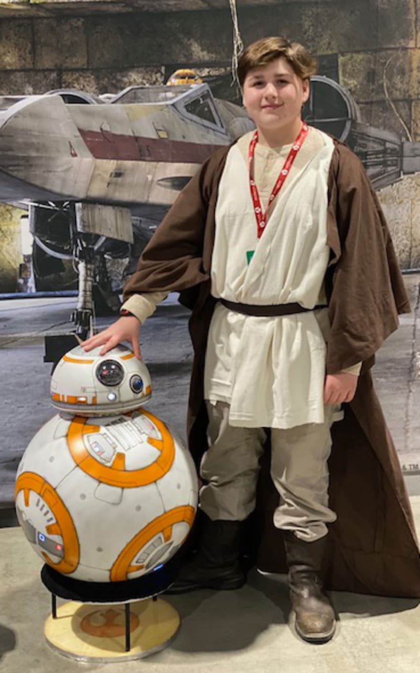 a kid dressed up in a homemade jedi costume