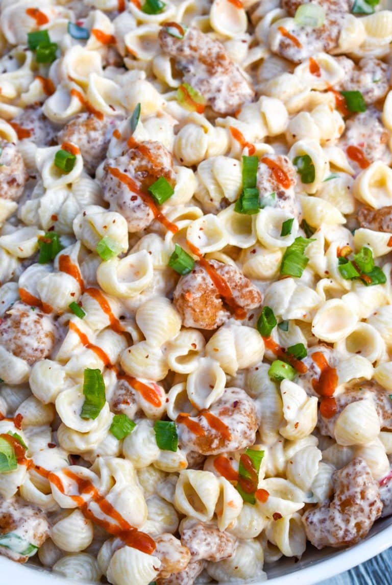 bang bang shrimp pasta salad in a large white serving bowl