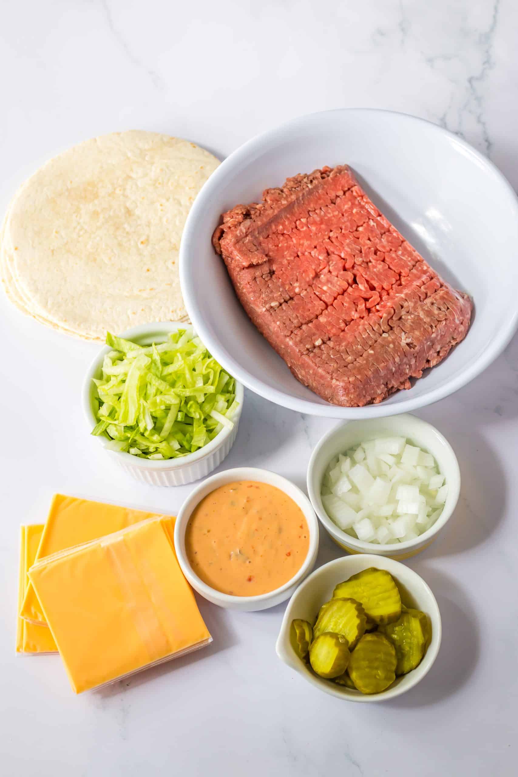an overhead image showing the measured ingredients needed to make a batch of big mac smash tacos