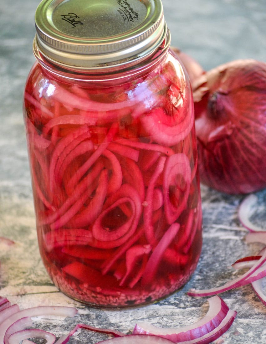 pickled red onions in a large glass mason jar