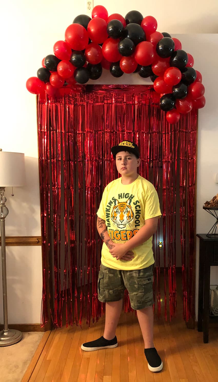 stranger things red tinsel door frame with a red and black balloon garland above it