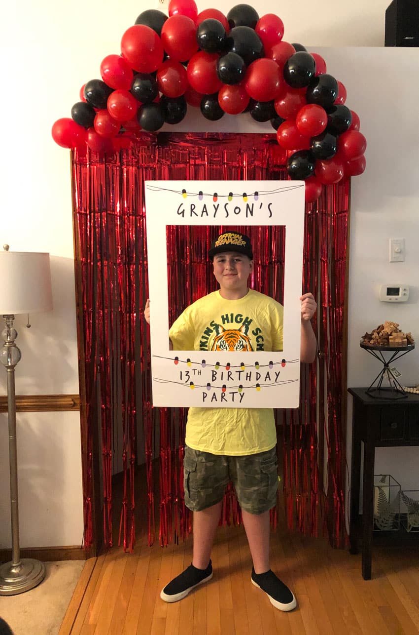 kid holding a custom polaroid birthday cutout selfie sign