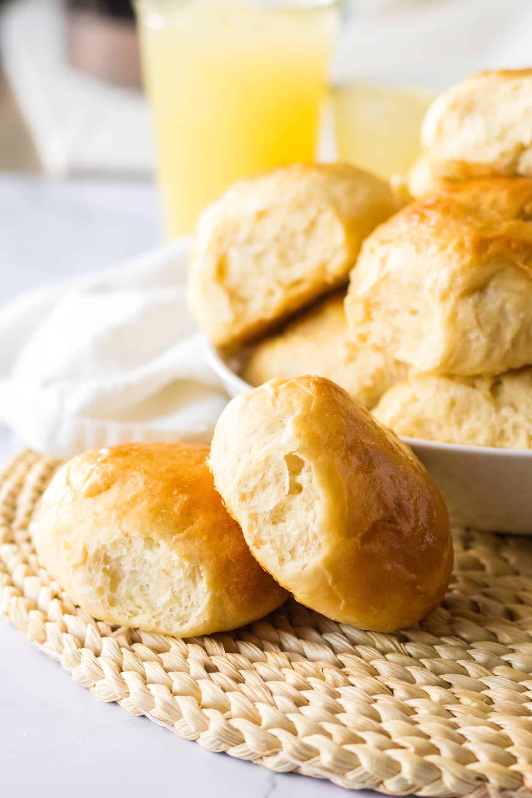 homemade sweet hawaiian rolls piled in a shallow white bowl