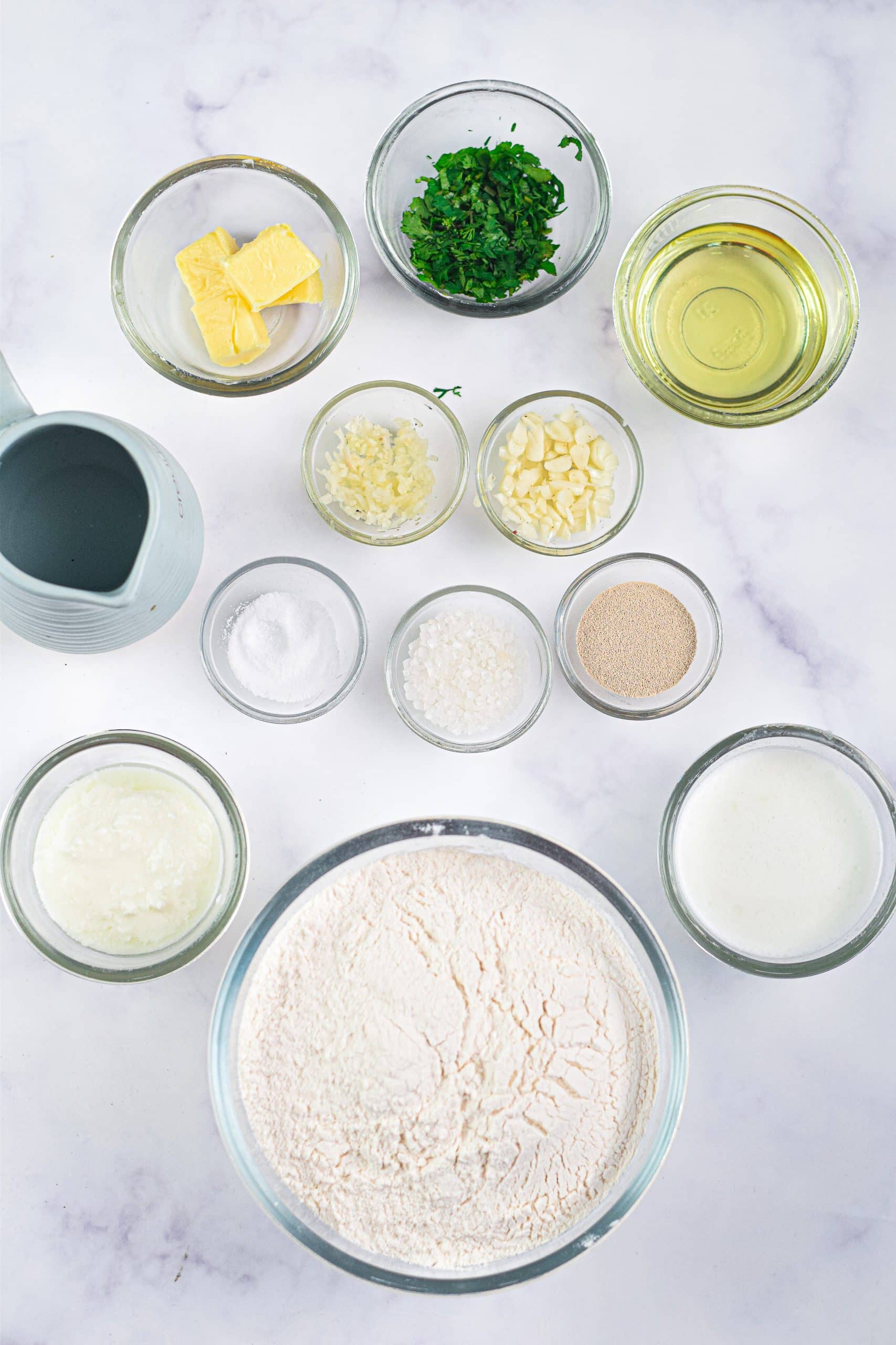 an overhead image showing the measured ingredients needed to make a batch of garlic naan bread in the air fryer