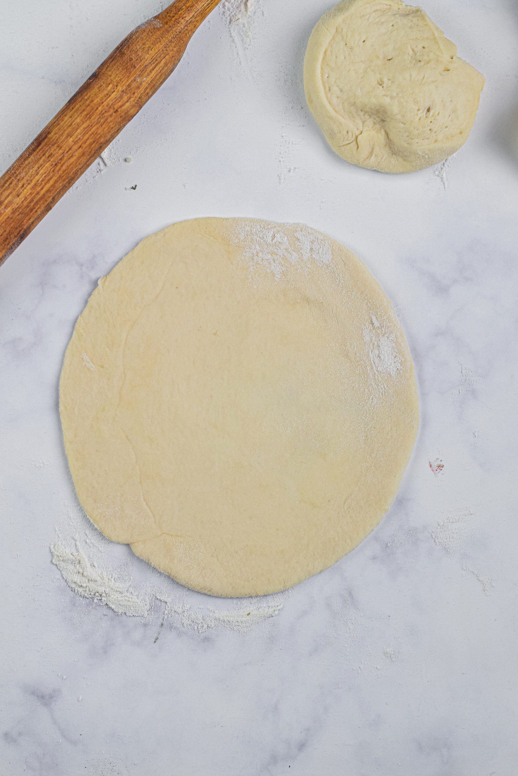 rolled out flattened circles of dough on a floured surface