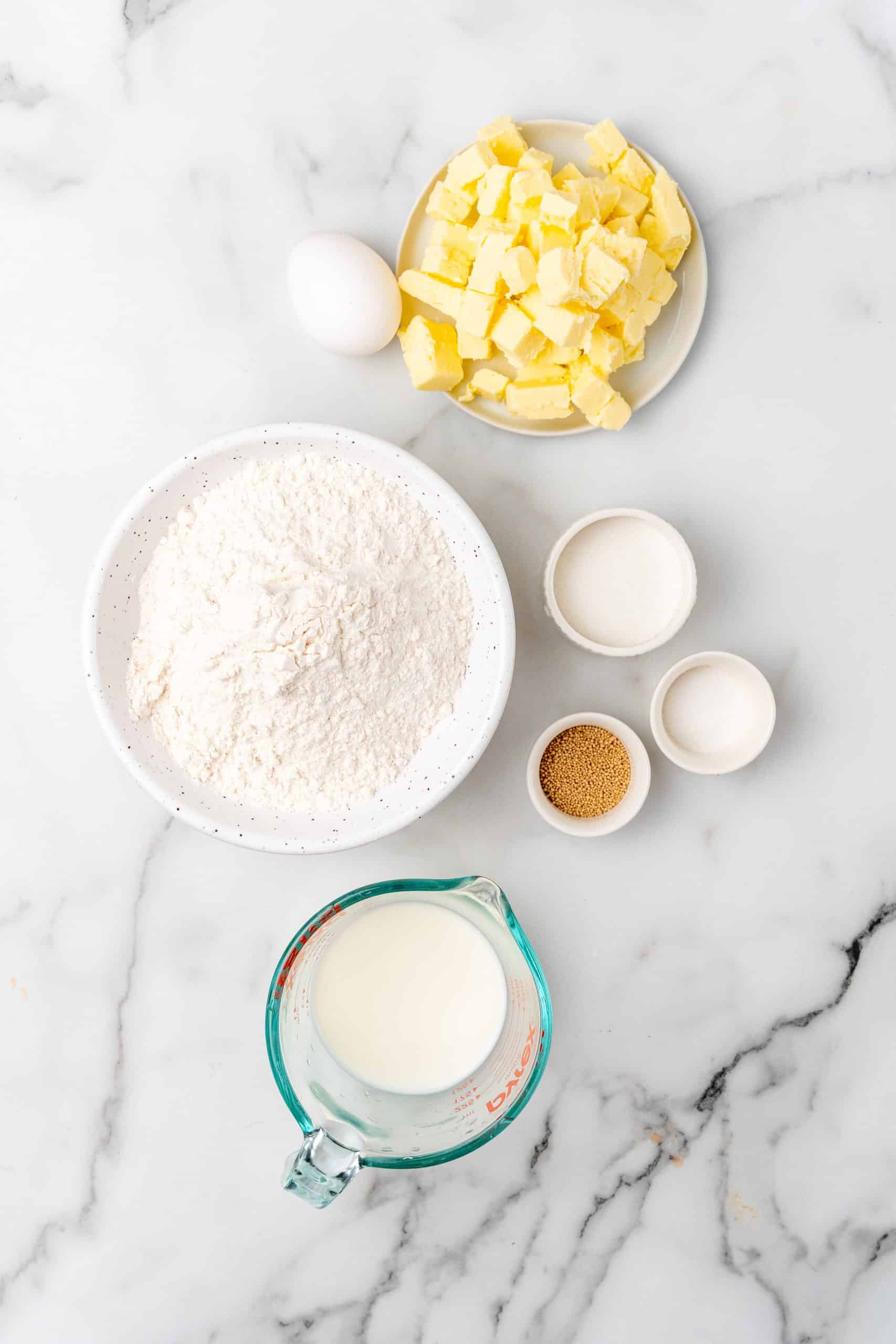 an overhead image showing the measured ingredients needed to make a homemade butter croissant recipe