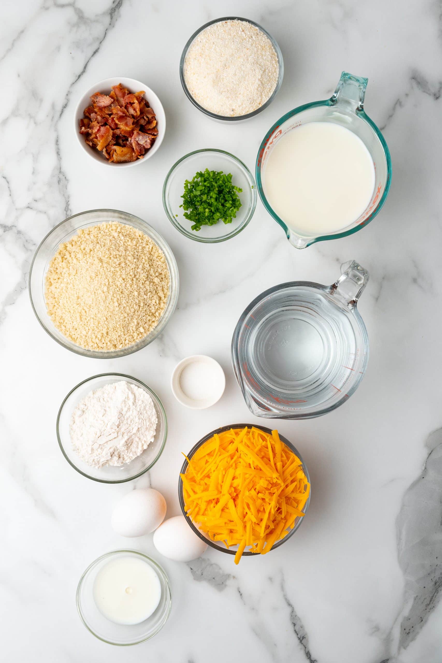 an overhead image showing the measured ingredients needed to make a batch of leftover grits fritters