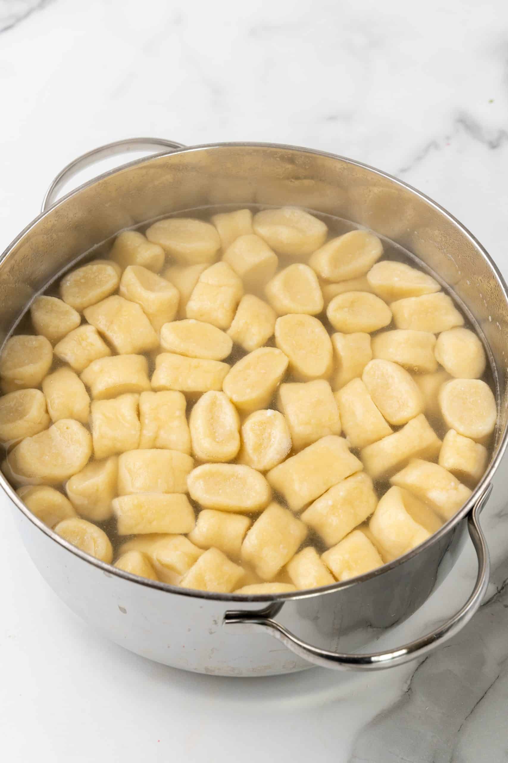 cooked homemade gnocchi in pot of boiling water