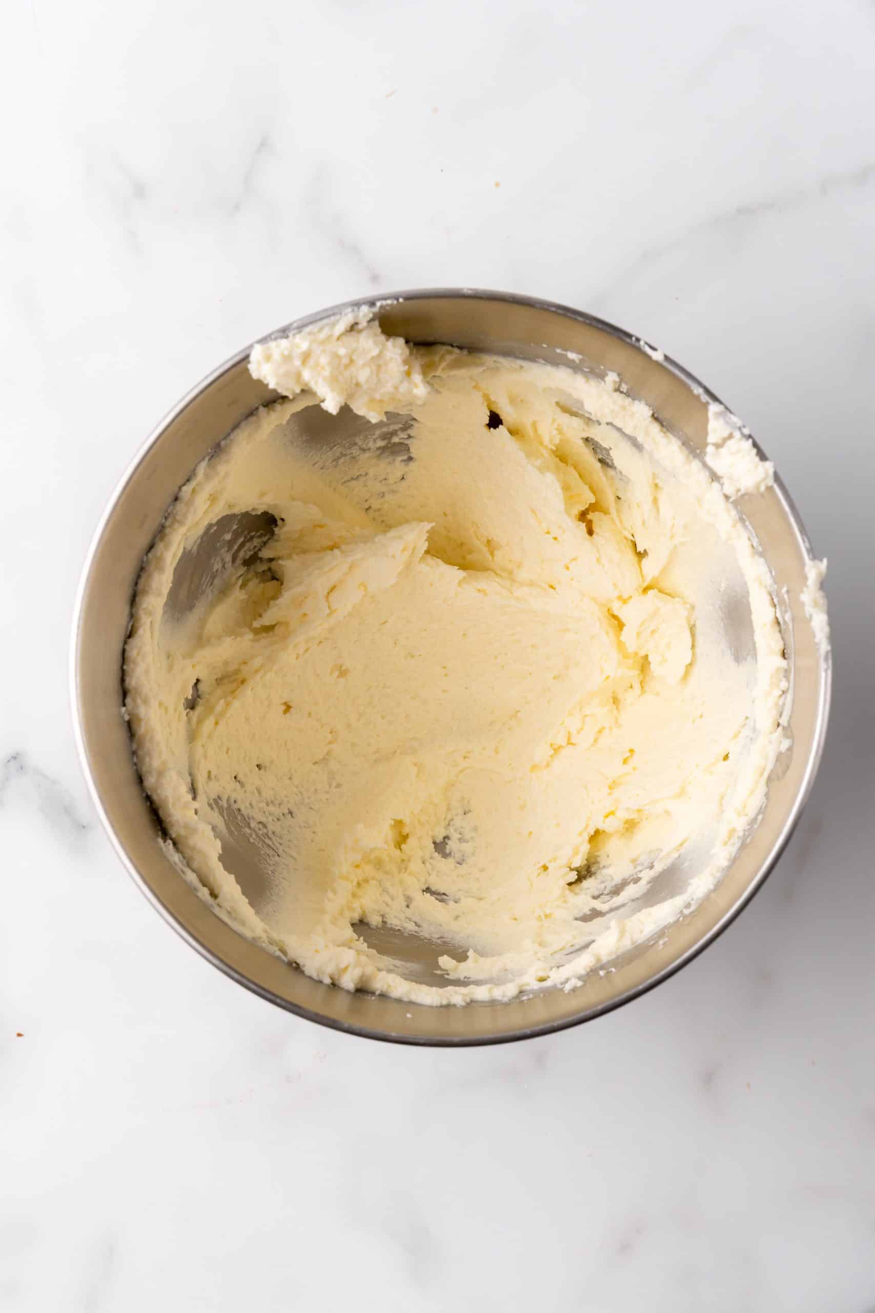creamy whipped butter in a silver mixing bowl