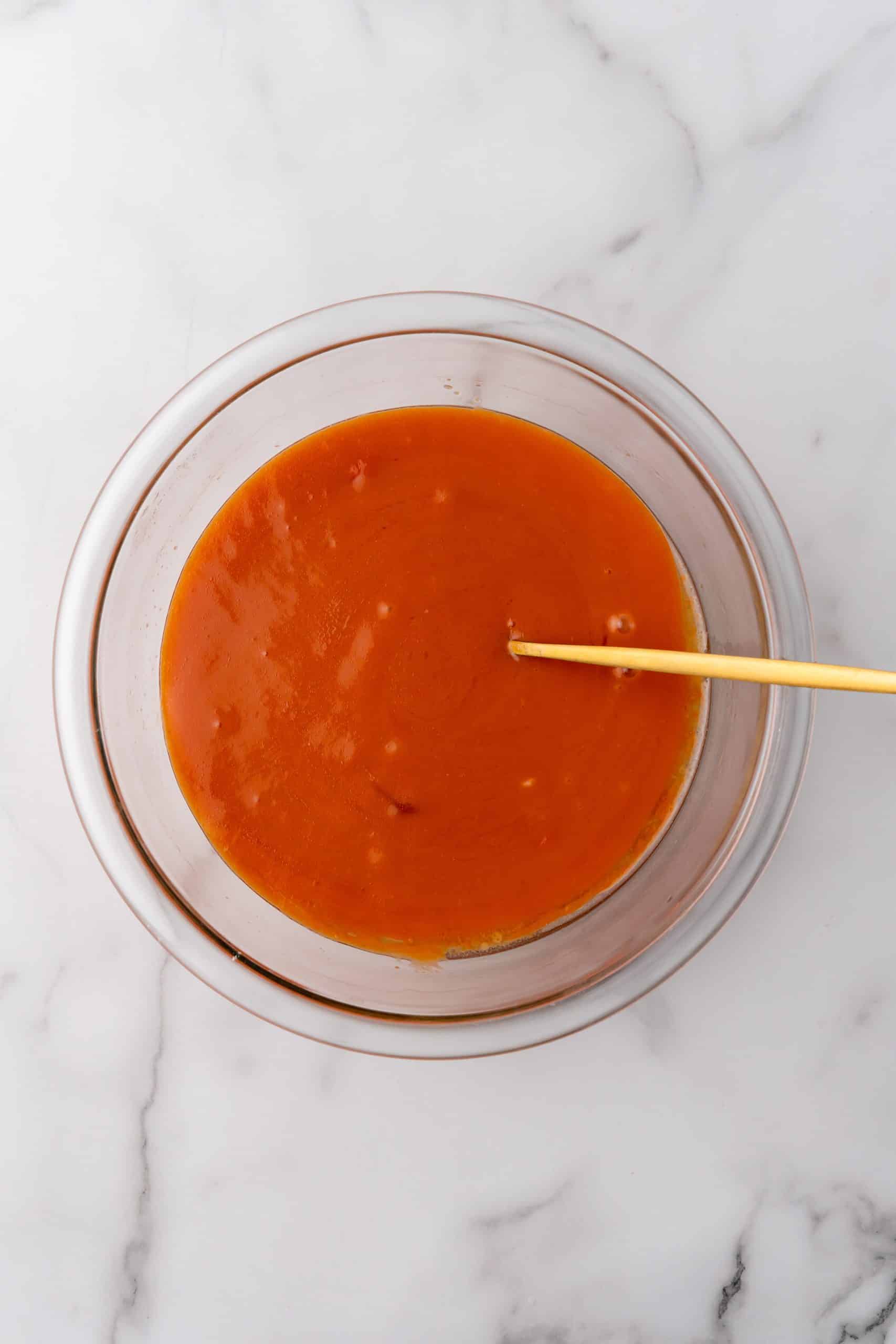 tomato soup and egg mixture in a glass mixing bowl