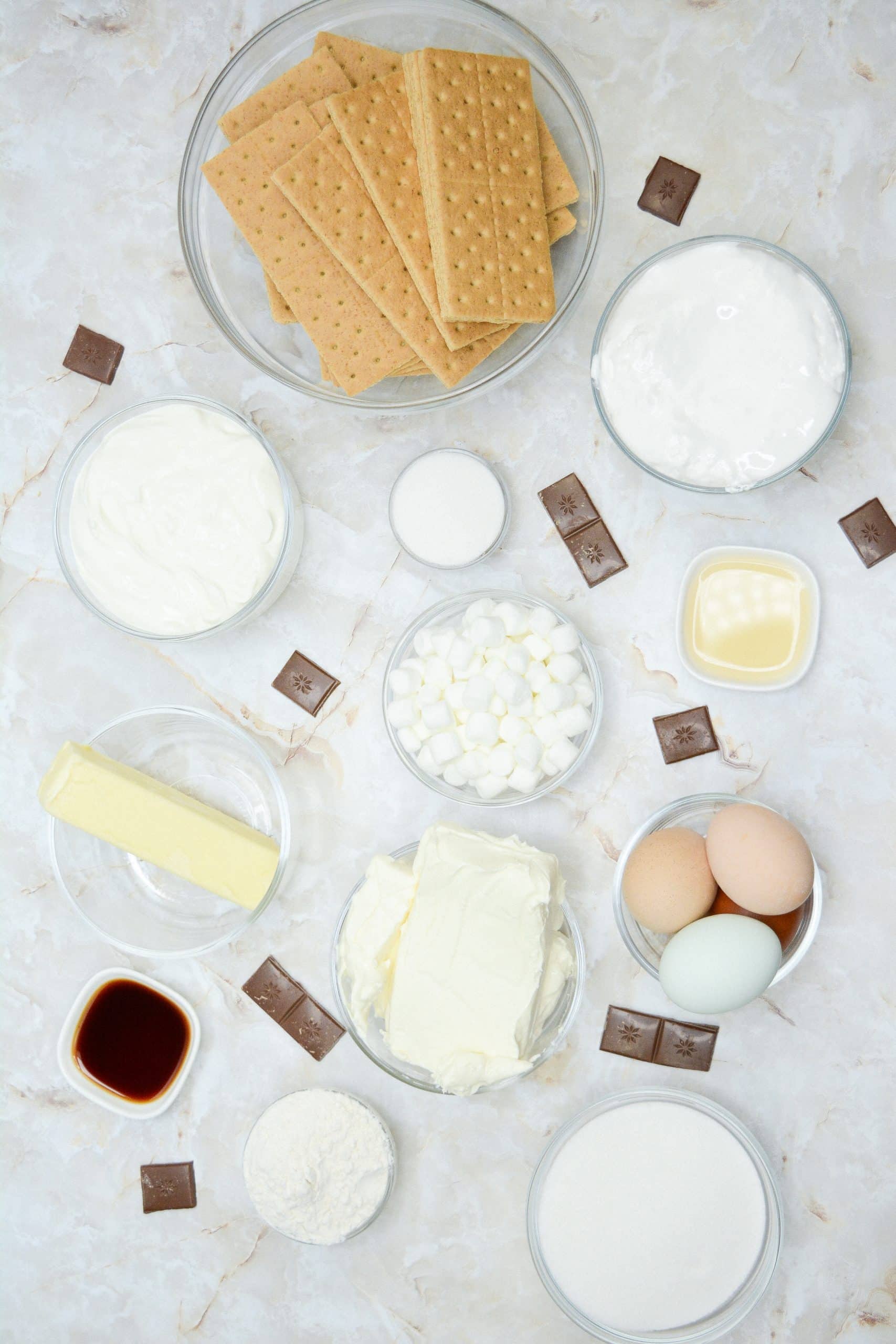an overhead image showing the measured ingredients to make a batch of mini s'mores cheesecake