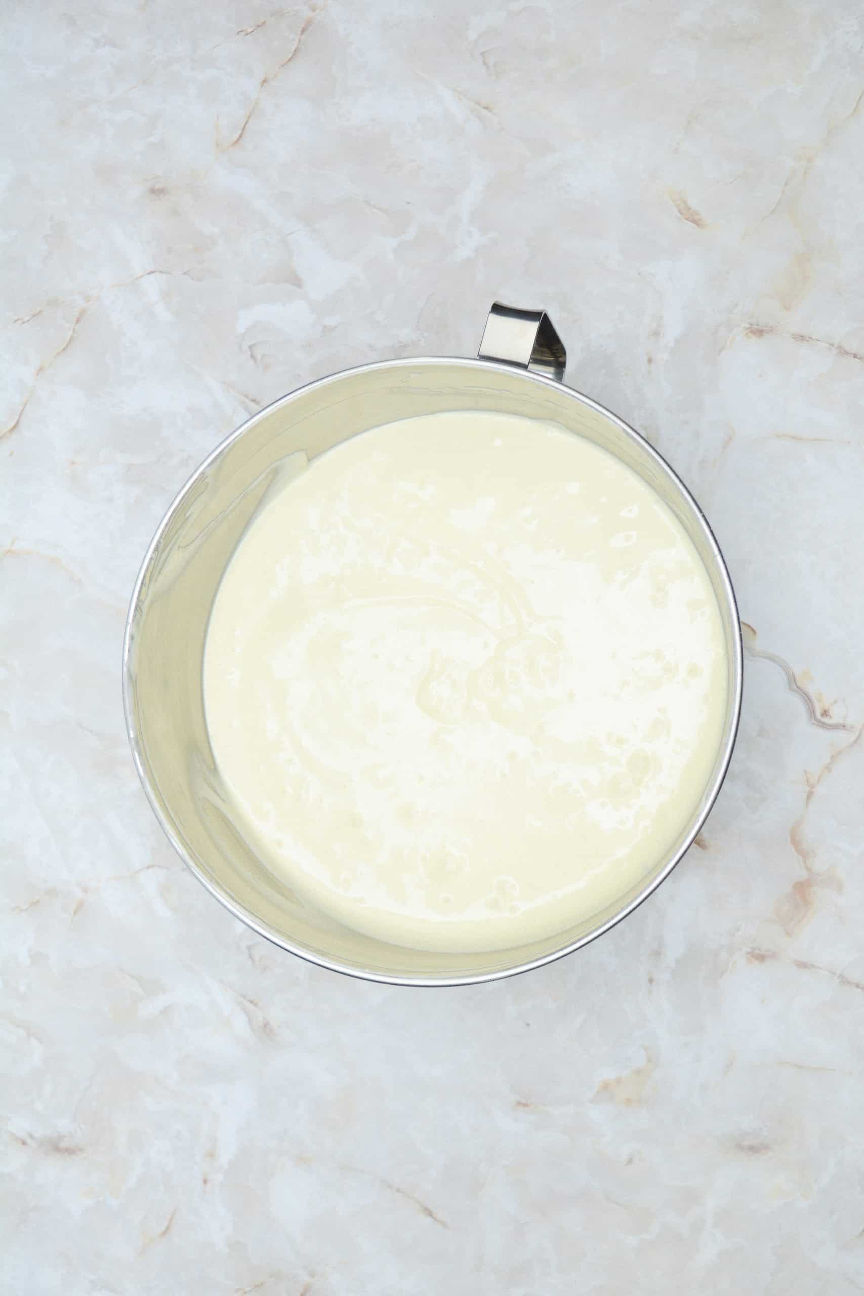 cheesecake batter in a metal mixing bowl