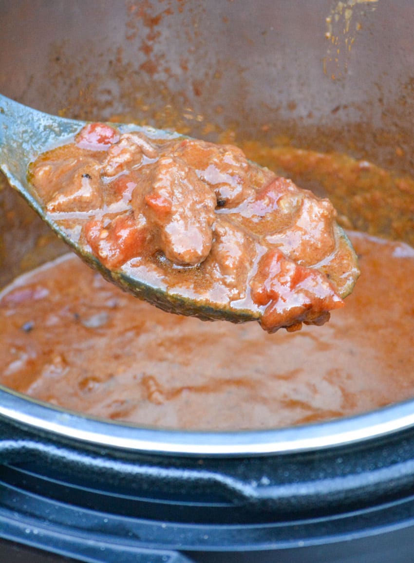 a spoon scooping Hungarian goulash out of the bowl of an Instant Pot