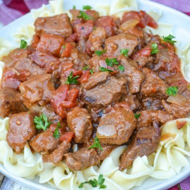 Instant Pot Hungarian goulash over egg noodles on a white plate