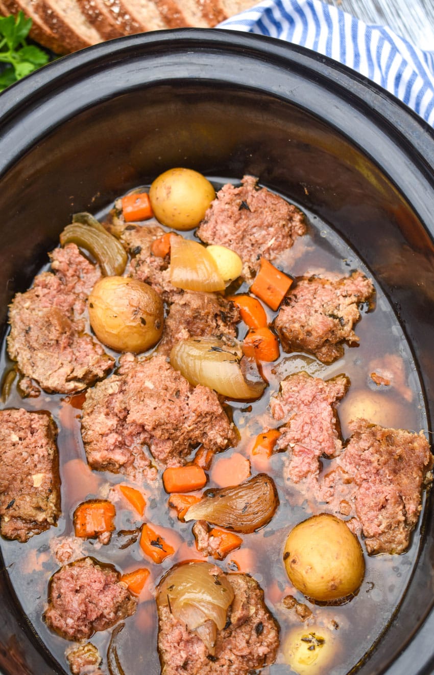 slow cooker corned beef hash in the black bowl of a crockpot