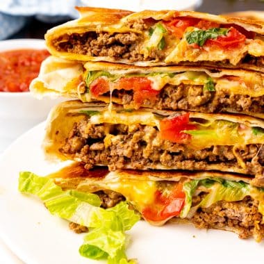 copycat crunchwrap supremes stacked on a white plate