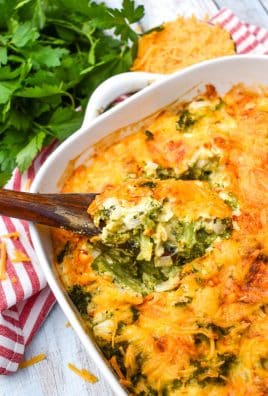 a wooden spoon in a casserole dish filled with cheesy broccoli souffle