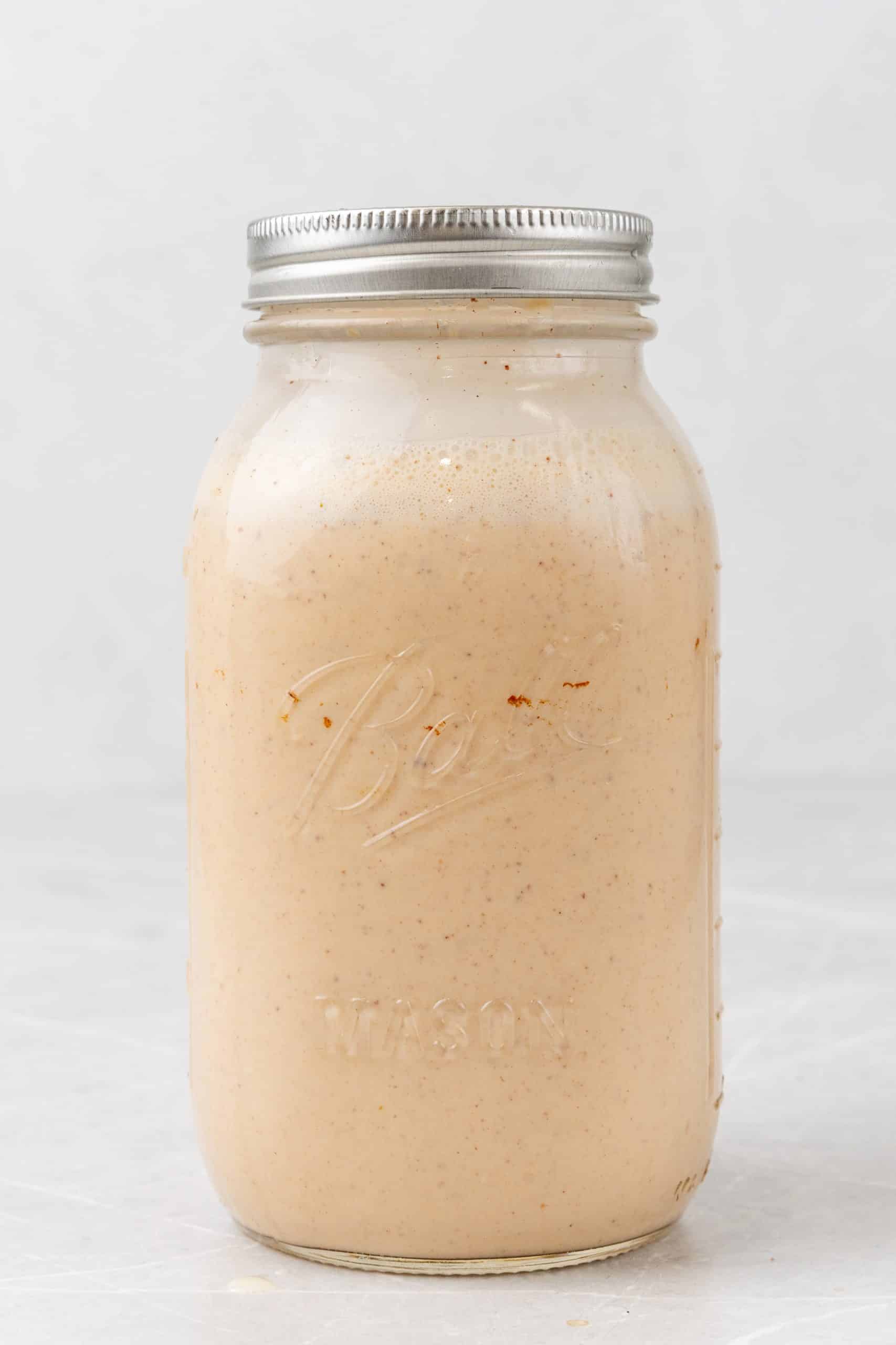 homemade pumpkin spice coffee creamer in a large glass mason jar