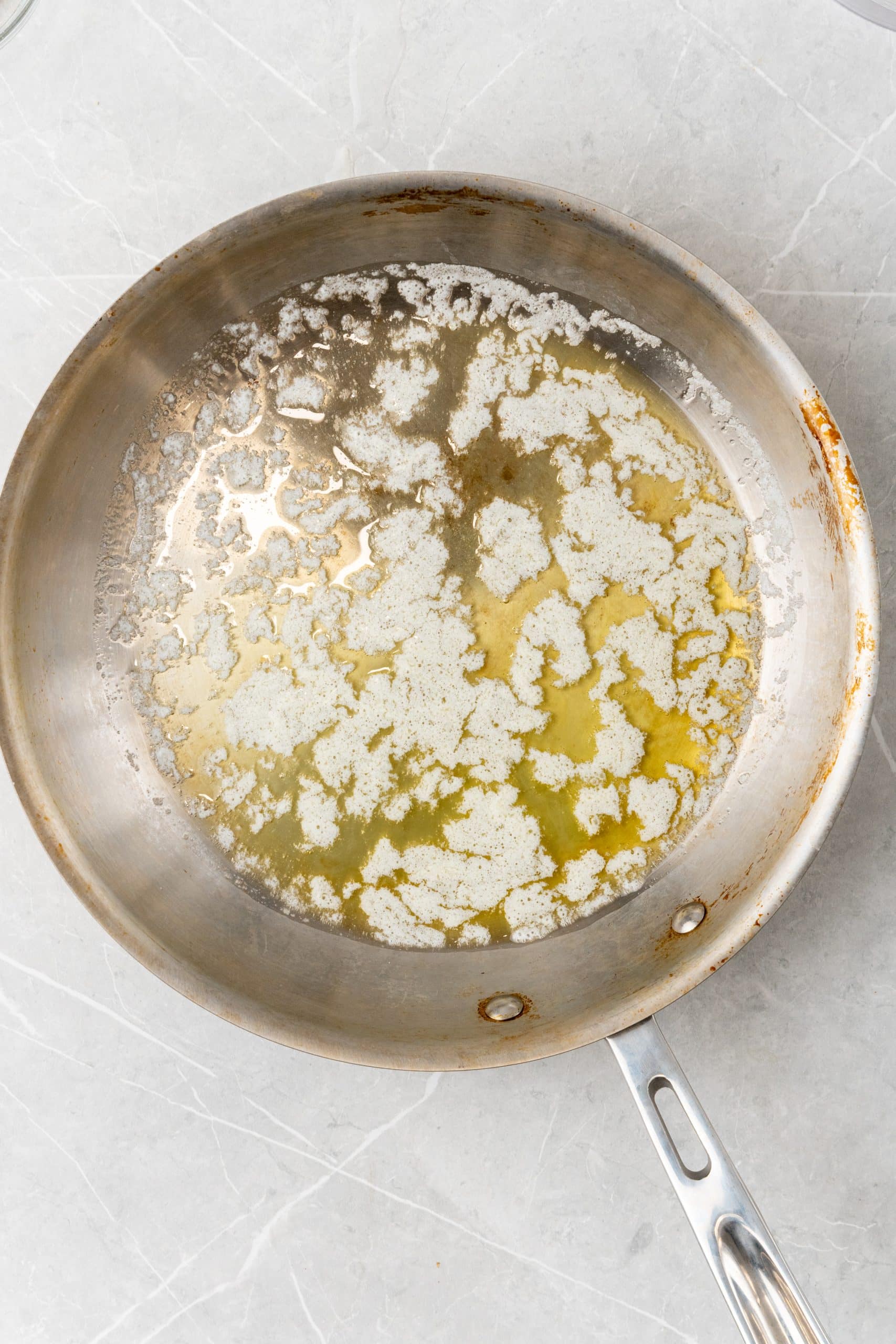 melted salted butter in a silver skillet