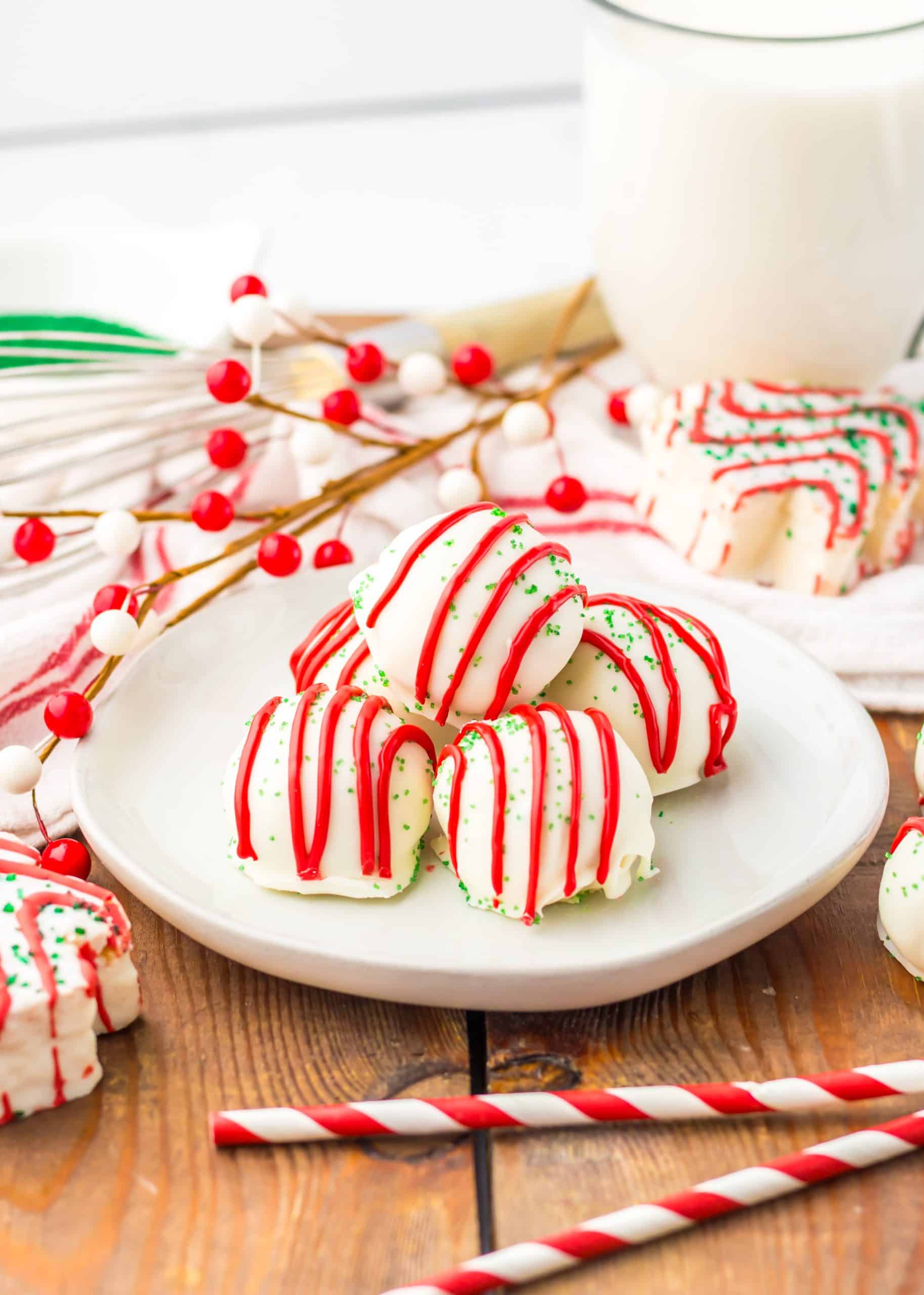 a pile of little debbie christmas tree cake truffles on a small white plate