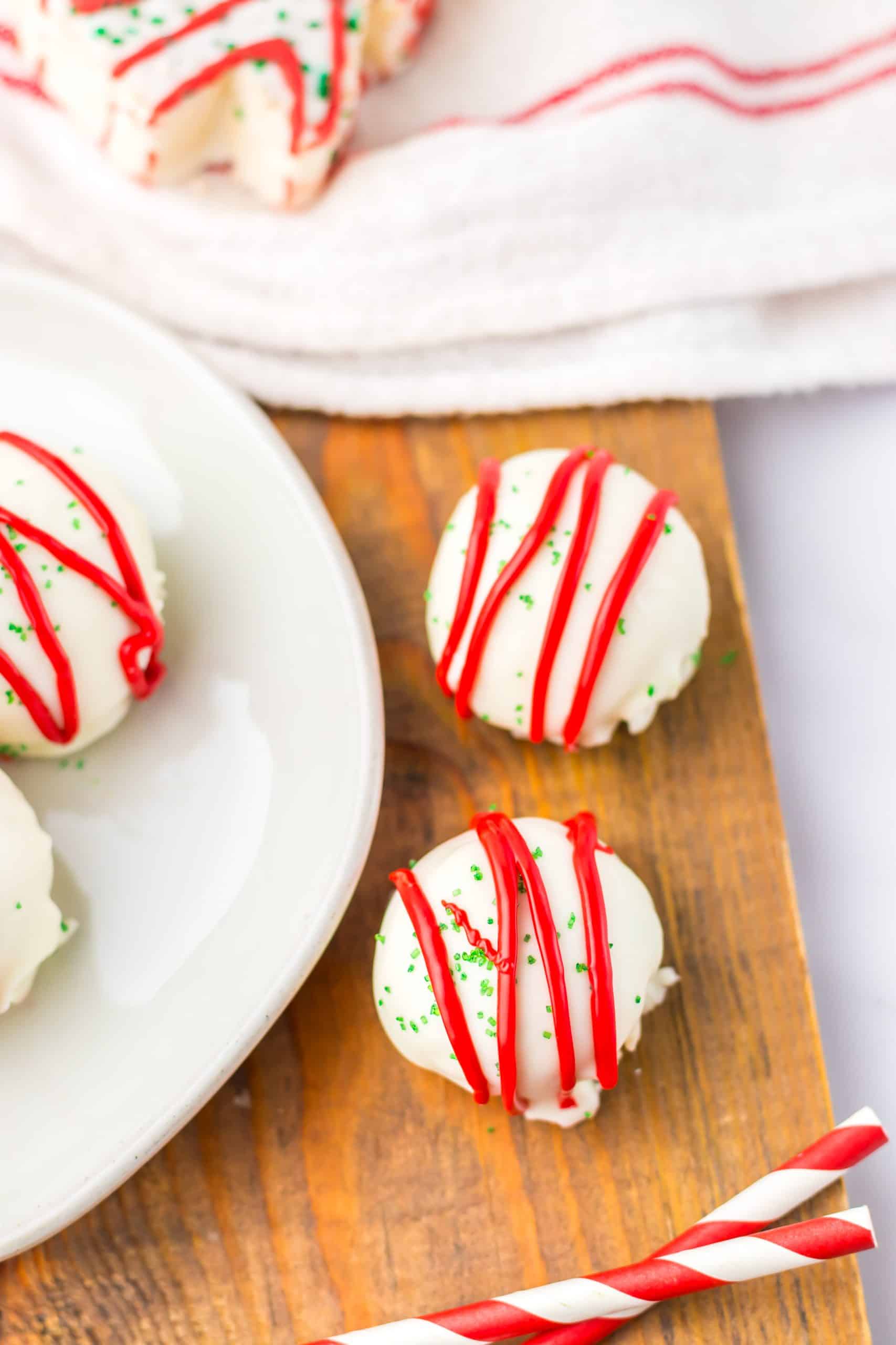 two little debbie christmas tree cake balls on a wooden cutting board