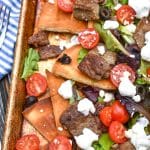 gyro nachos on a large metal sheet pan