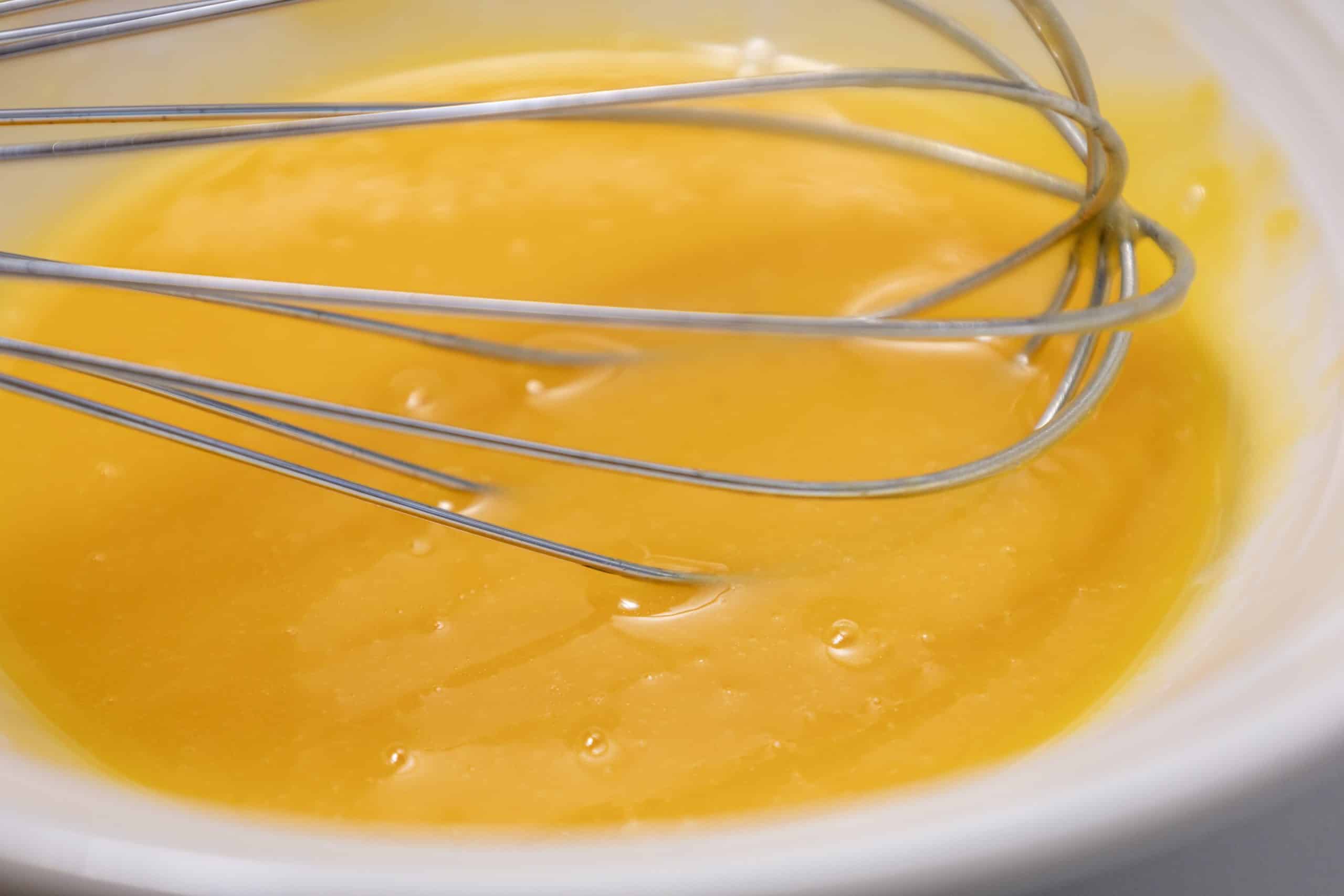 easy homemade mayonnaise being whisked together in a shallow dish