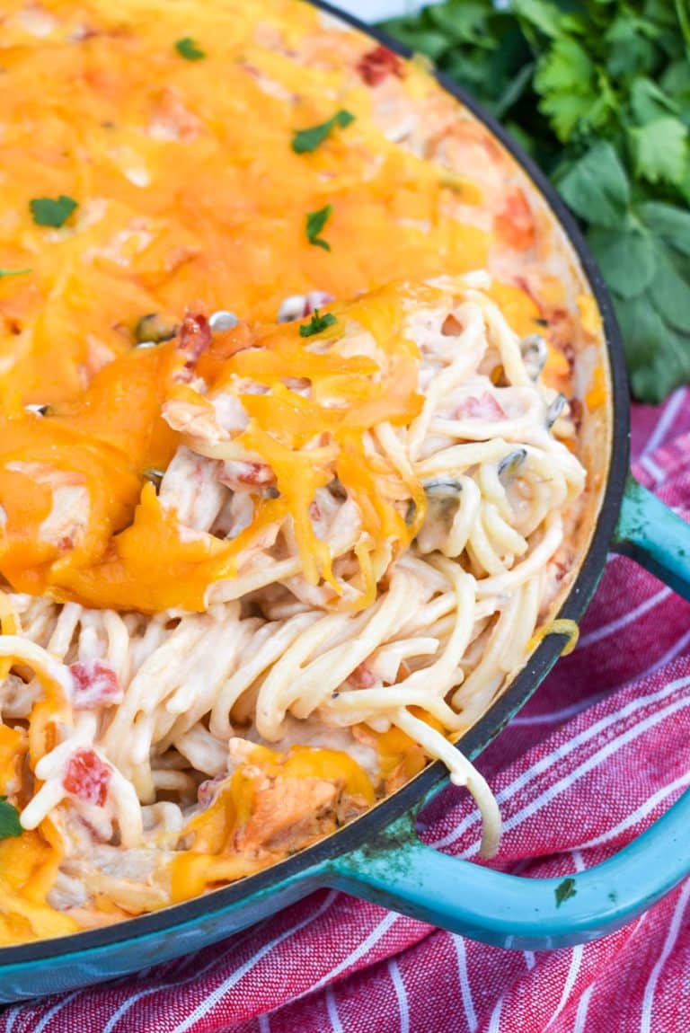 cheesy mexican chicken spaghetti in a blue cast iron skillet