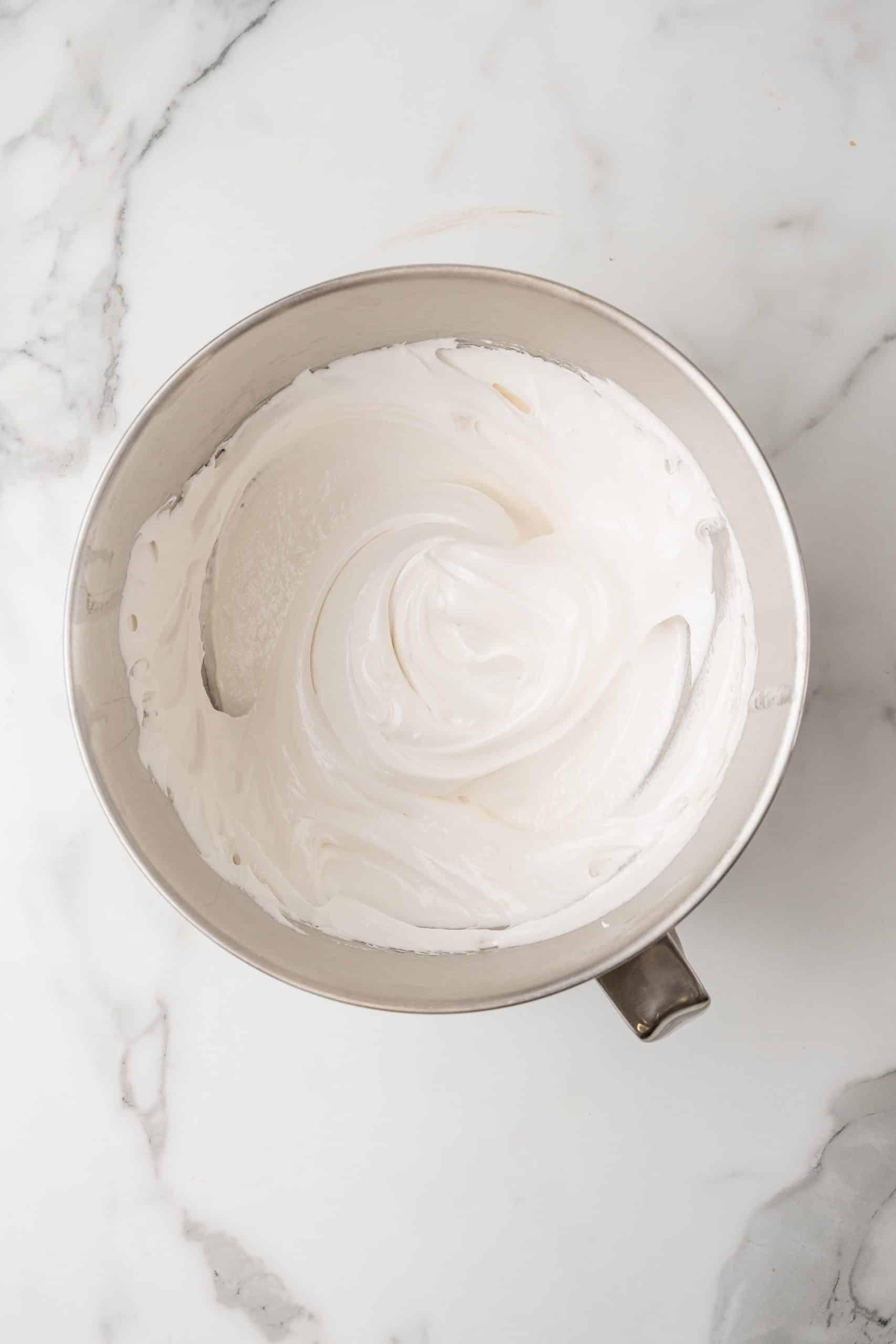 marshmallow fluff frosting in a silver mixing bowl