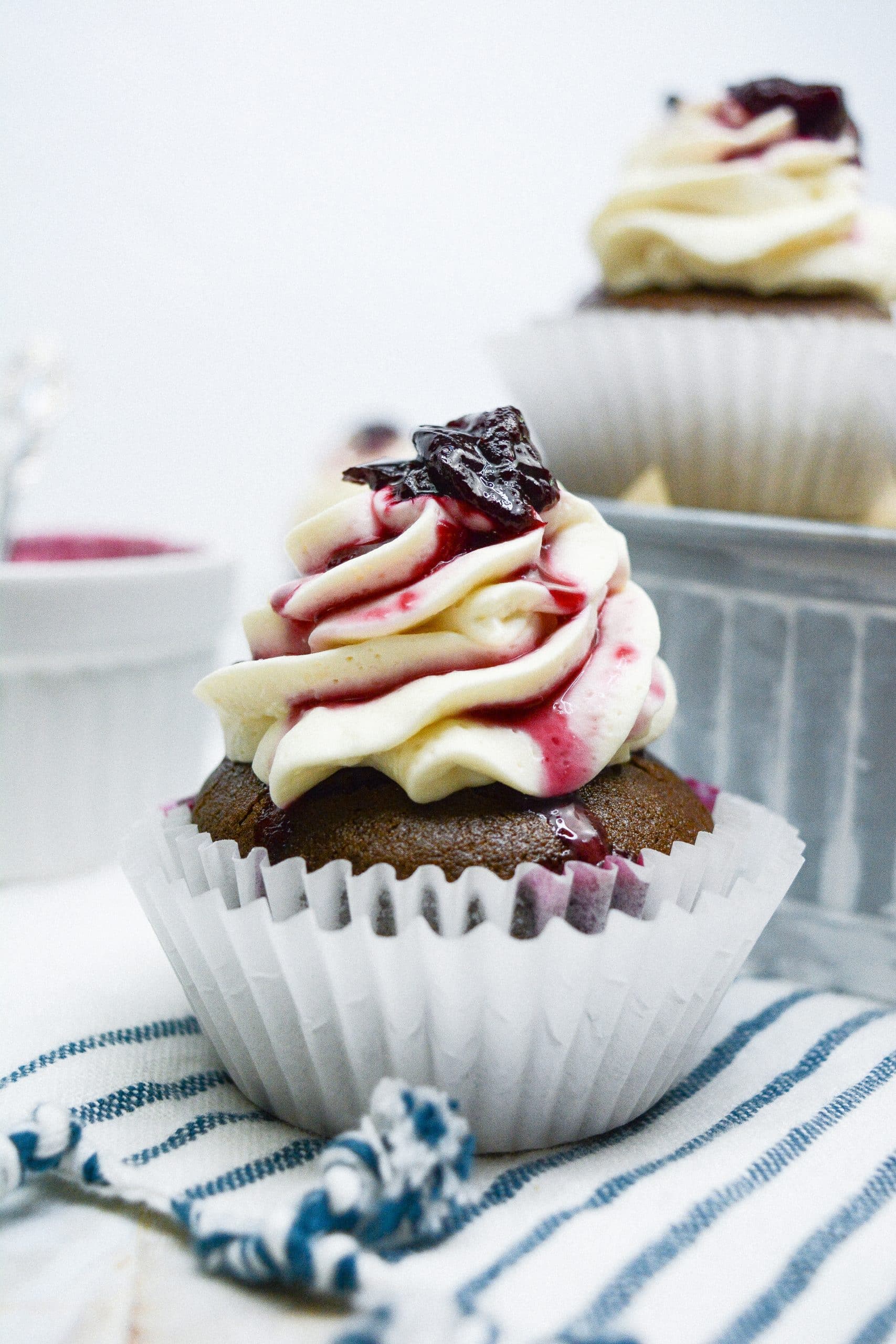 black forest cupcake sitting on a white and blue striped cloth napkin