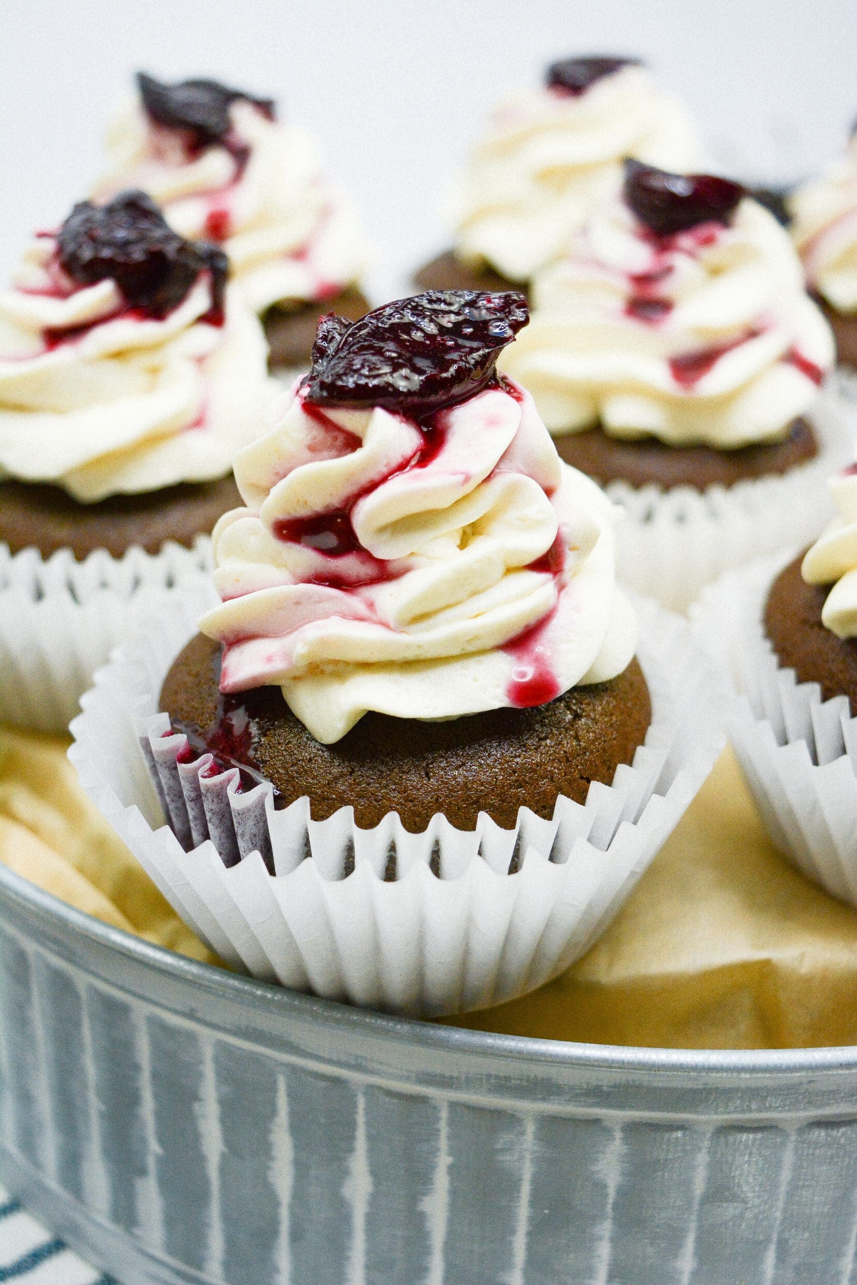 black forest cupcakes on a metal cake stand