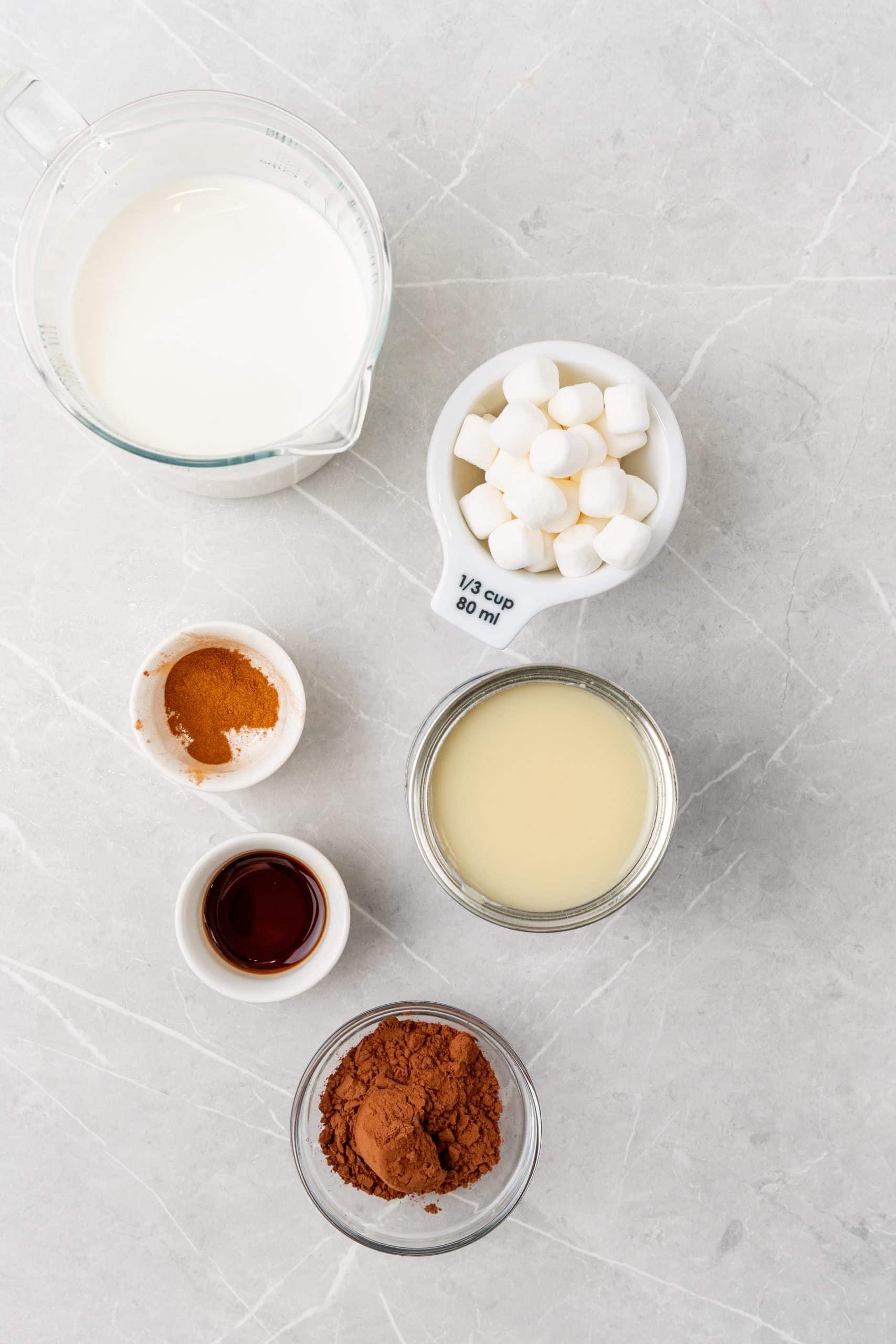 an overhead image showing the measured ingredients needed to make a batch of s'mores flavored coffee creamer