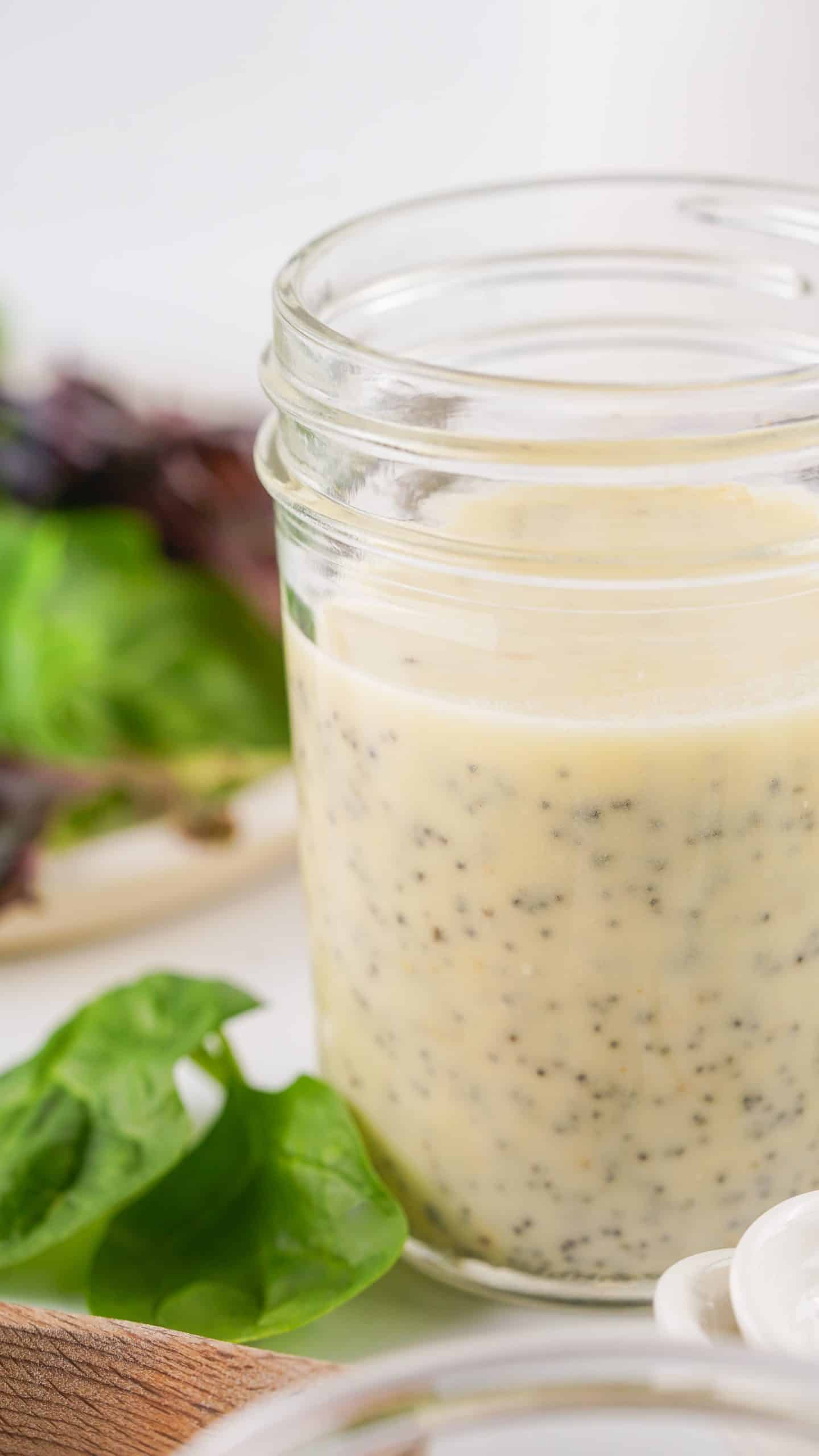 creamy poppyseed dressing in a small glass mason jar