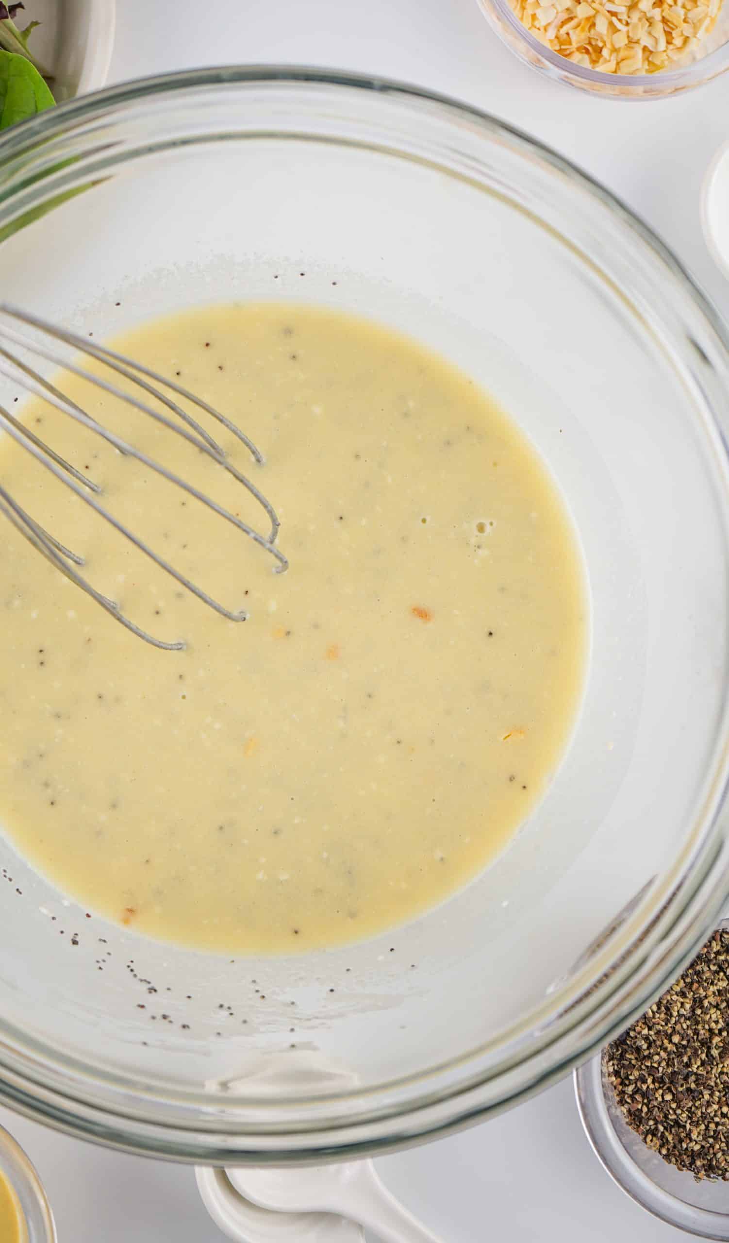 homemade poppy seed dressing in a glass bowl
