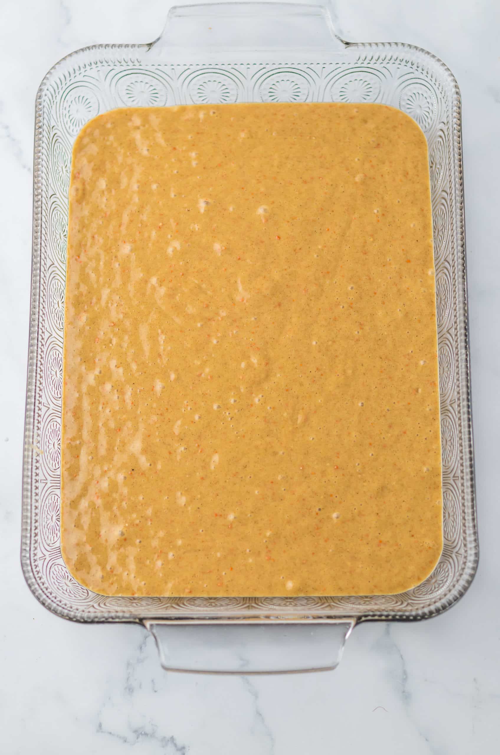 carrot cake batter in a large 9x13 inch glass baking dish