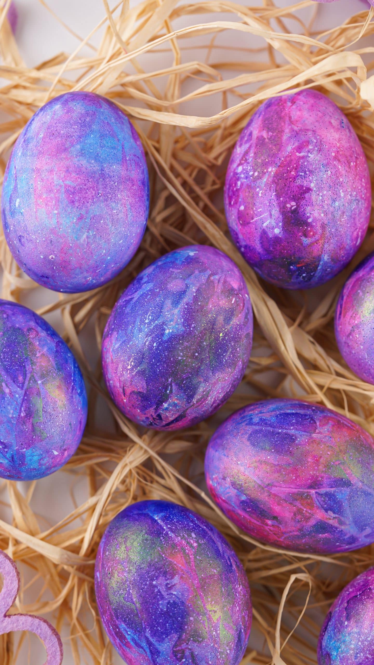 easter dyed galaxy eggs arranged in straw