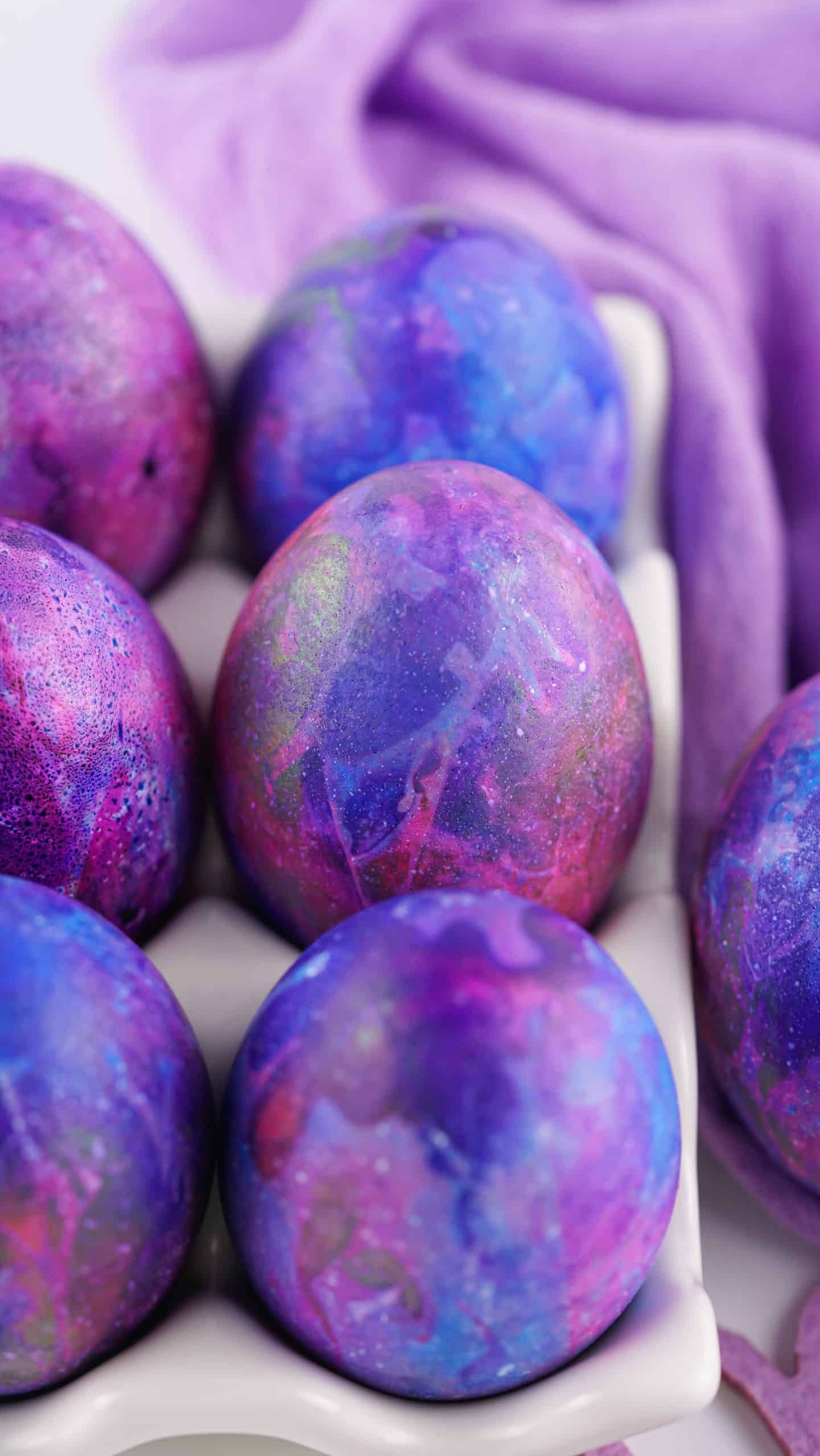 easter dyed galaxy eggs in a white egg holder