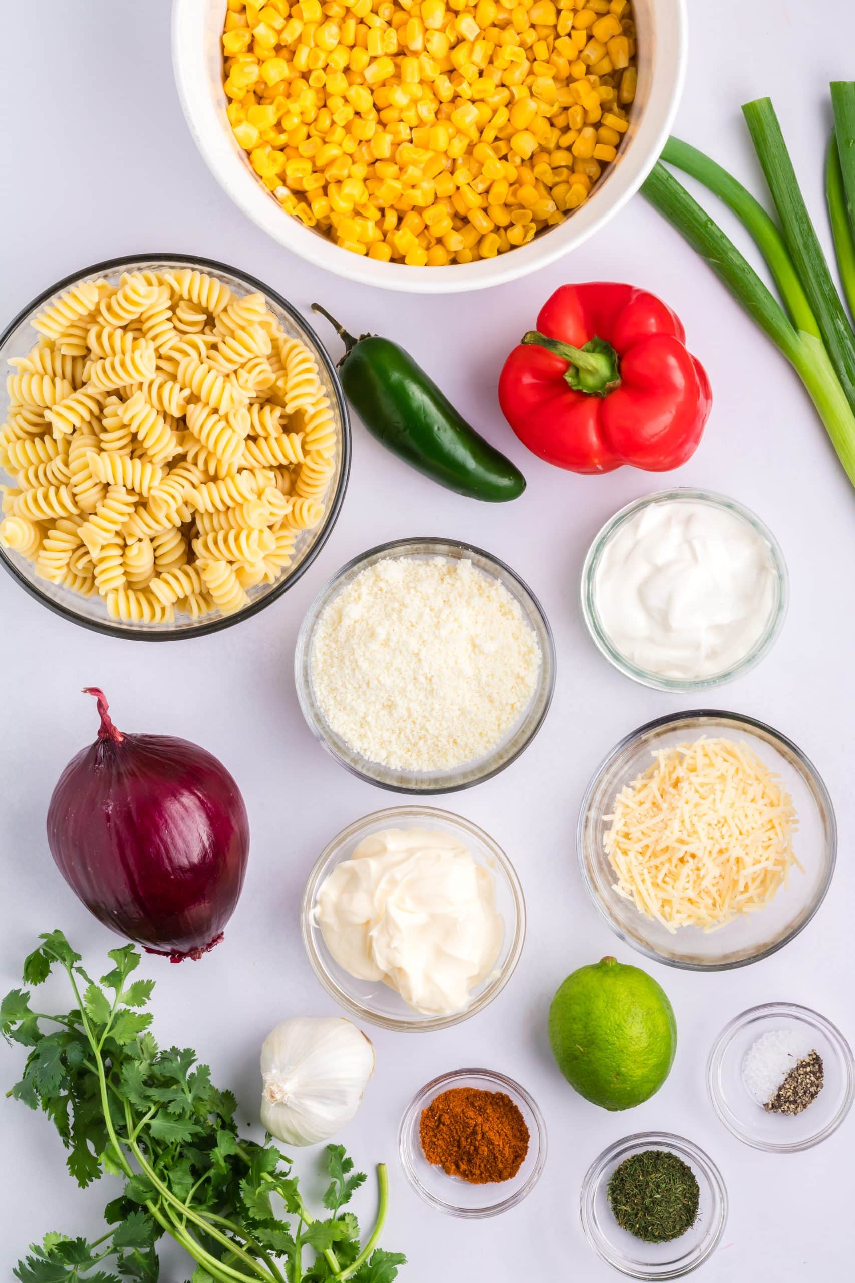 overhead image showing the ingredients needed to make a batch of mexican street corn salad