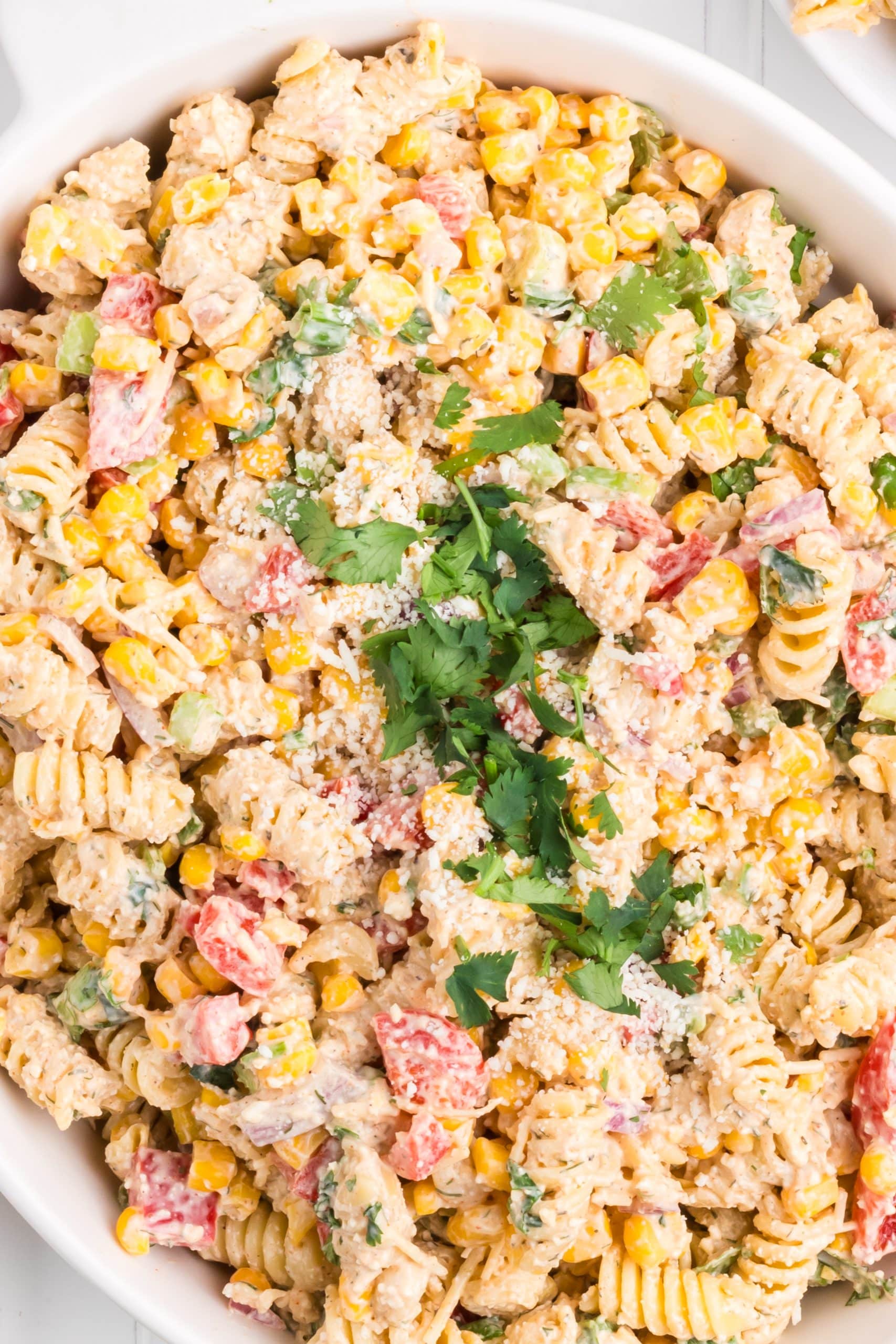 mexican street corn pasta salad in a white serving bowl