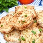 air fryer fried red tomatoes piled on a white plate